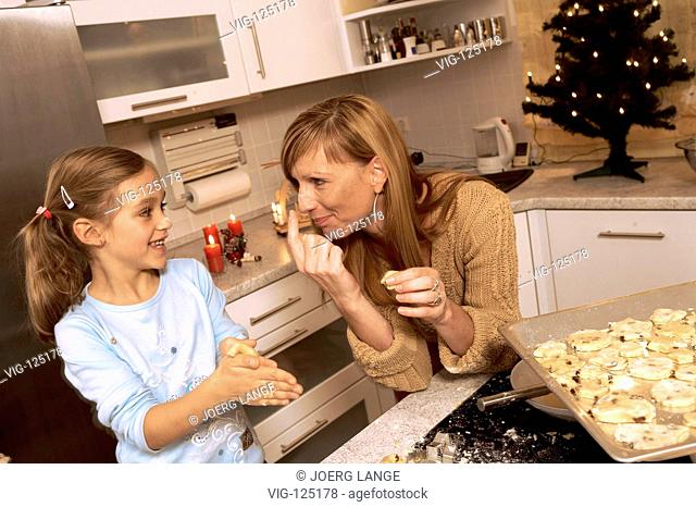 A young mother is baking christmas cookies with her children. - LEIPZIG, GERMANY, 18/10/2005
