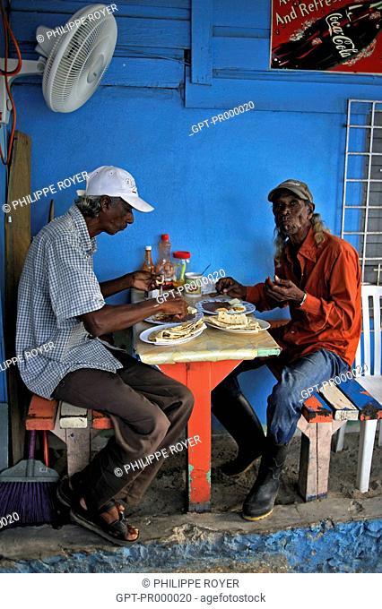 TWIN BELIZIAN BROTHERS HAVING THEIR MEAL, BELIZE, CENTRAL AMERICA