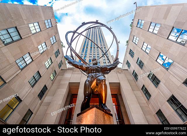 New York City, USA - July 2 2017 - Atlas statue in the Rockfeller Center, situated facing Saint Patrick Cathedral, represent the Titan supporting the celestian...