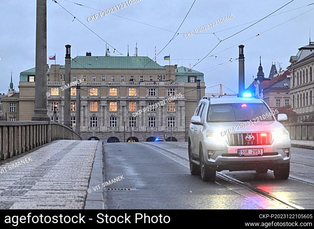 A police car passes over the closed Manes Bridge from Jan Palach Square, where the shooting took place in the building of the Faculty of Arts (in the...