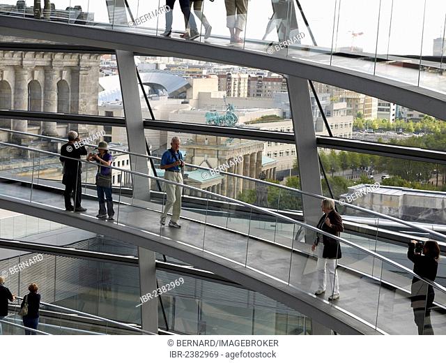 Tourists and visitors inside the dome of the Reichstag Building with views of the Brandenburg Gate, Berlin, Germany, Europe