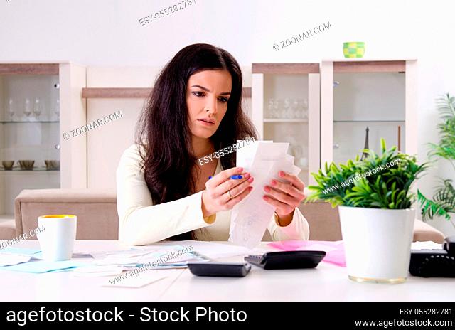 Young woman with receipts in budget planning concept