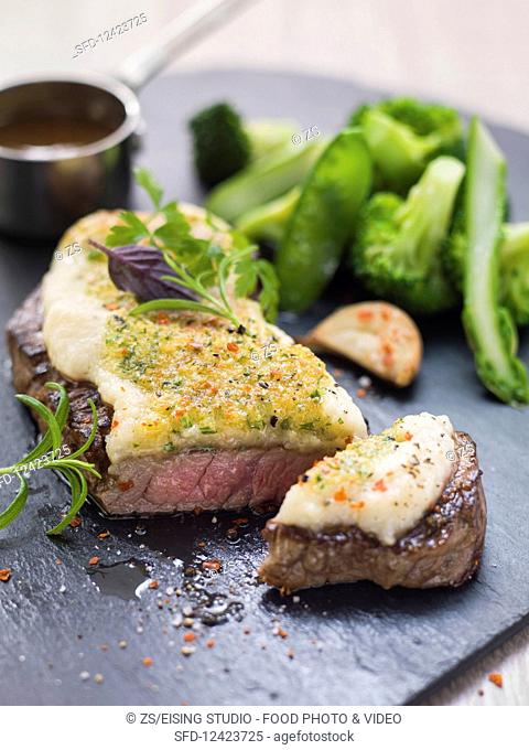 Roast beef with gratin celery puree on green vegetables