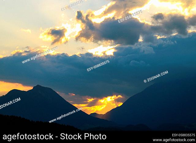 Beautiful sunset high in the mountains. Silhouette of mountains