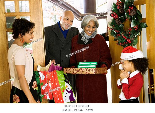 African American grandparents arriving with Christmas gifts