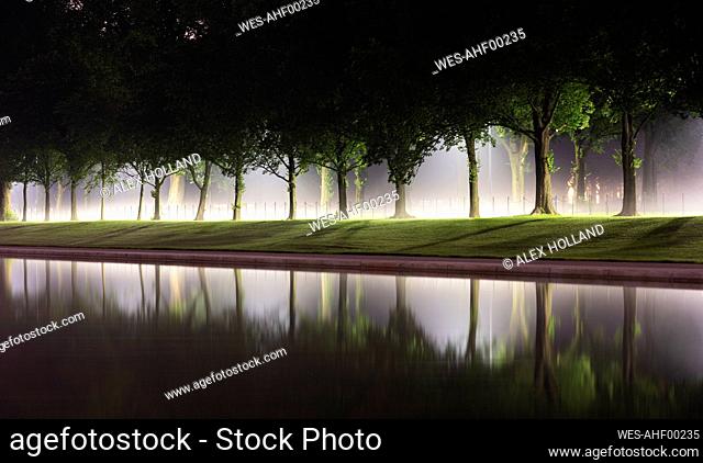 USA, Washington DC, Treelined edge of Lincoln Memorial Reflecting Pool at night