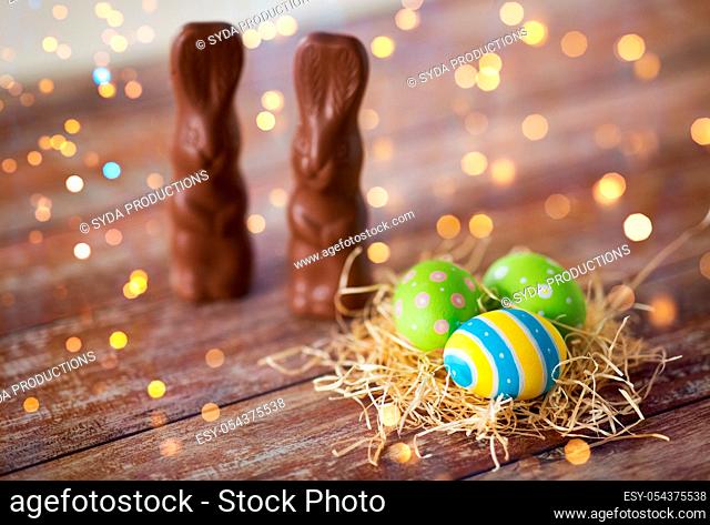 easter eggs in straw nest and chocolate bunnies