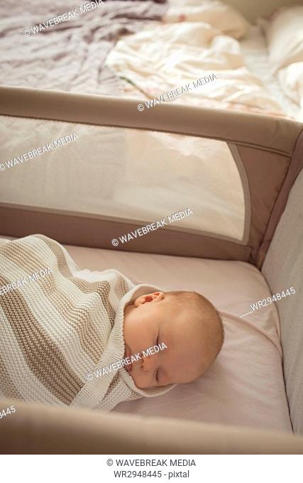 Cute baby sleeping in crib