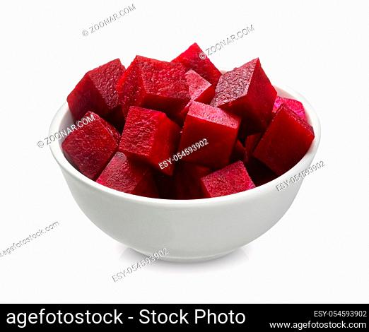 Sliced beet closeup, cut beetroot cubes in bowl isolated on white background with clipping path