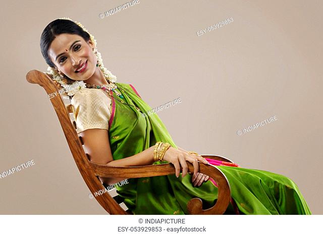South Indian woman sitting on an arm chair