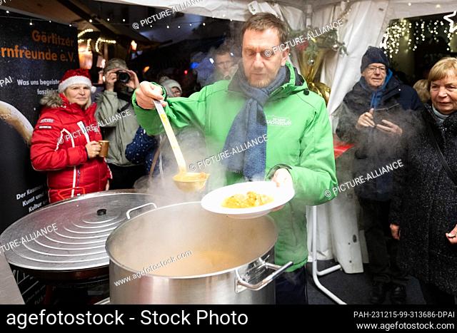 15 December 2023, Saxony, Görlitz: Michael Kretschmer (CDU, M), Minister-President of Saxony, distributes food as part of the ""17 days! 17 meals! 17 o'clock""...