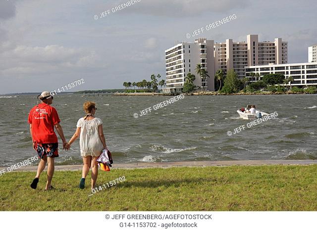 Florida, Fort Ft  Myers, San Carlos Bay, Punta Rassa, waterfront, man, woman, couple, walking, choppy water, boat, building