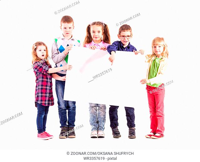 Group of children isolated on white background are holding a white poster with copyspace