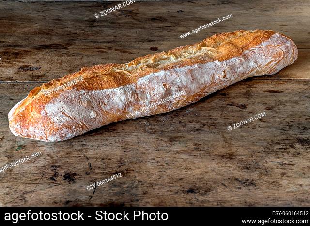 Baguette bread on a wooden table. Bread specialty in France