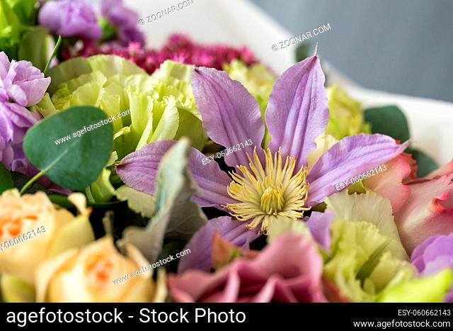 Close-up floral composition with roses and mix flowers on a light background. caramel-cream gamma. close-up
