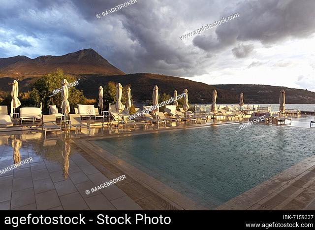 Hotel pool with view of Taygetos Mountains, evening light, sun and rain, Karovostasi, Itylo, Mani Peninsula, Lakonia, Peloponnese, Greece, Europe