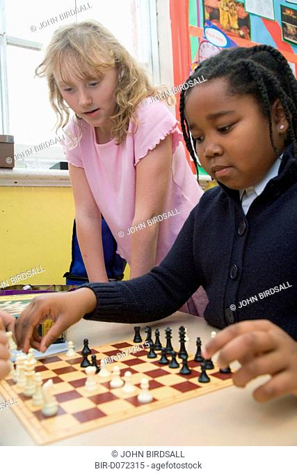 Two primary school children playing a game of chess in an after school club