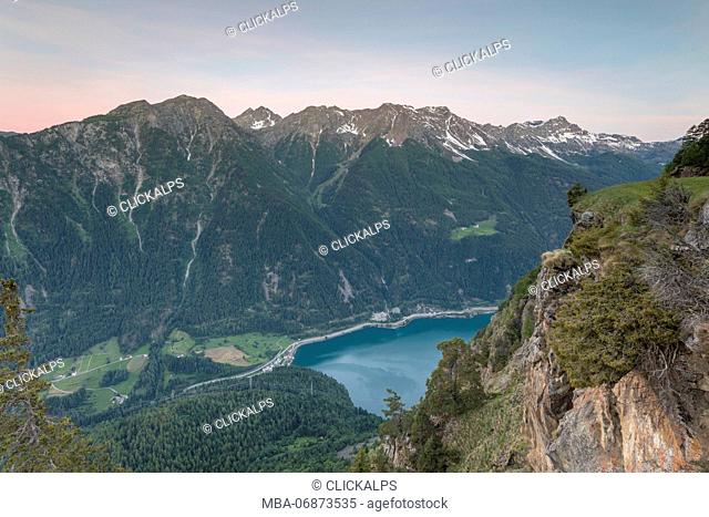 Overview of rocky peaks and lake at dawn, San Romerio Alp, Brusio, Canton of Graubünden, Poschiavo valley, Switzerland