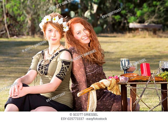 Pair of smiling women at outdoor pagan altar