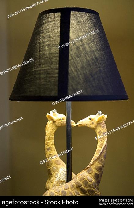 14 October 2020, Brandenburg, Groß Schönebeck: A bedside lamp with two giraffes kissing each other can be found in the ""Africa"" apartment of the Mound House