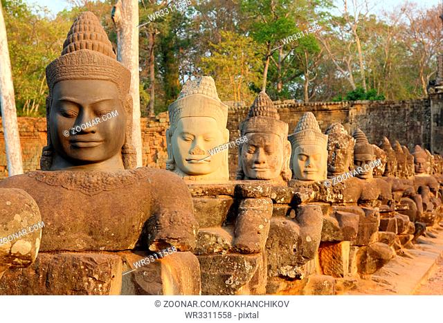 Stone carved statues of Devas on the bridge to Angkor Thom, Siem Reap, Cambodia