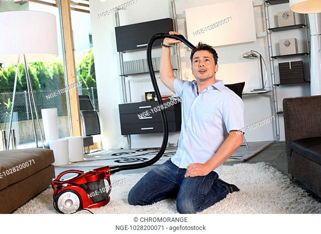 Man Twiddle with Vacuum Cleaner
