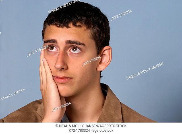 Worried look on face of young teenage man