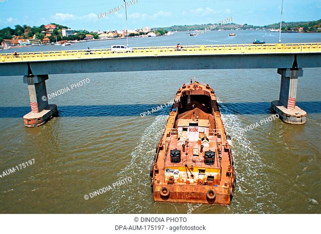 Iron ore transported through shipping on Mandovi river Panji  ; Goa  ;  India NOMR