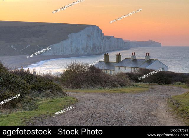 The cliffs and coastguard cottages of the Seven Sisters at dawn. From Seaford Head, South Downs, East Sussex, England, United Kingdom, Europe
