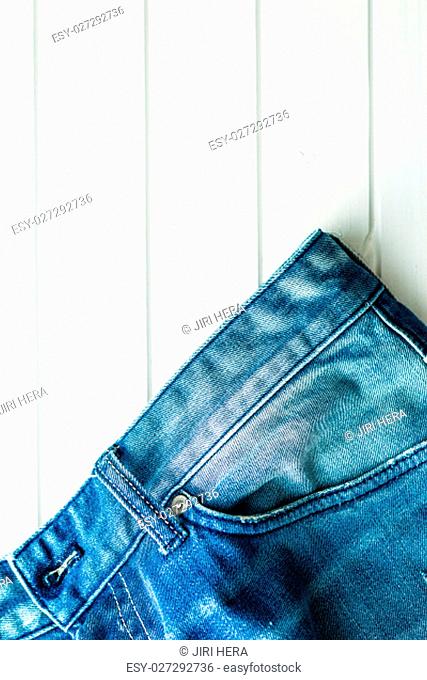 The blue jeans on white table. Top view