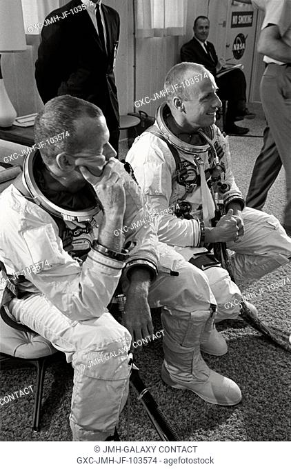 Astronauts Charles Conrad Jr. (right) and L. Gordon Cooper Jr. are pictured during suiting up operations before Gemini-5 spaceflight