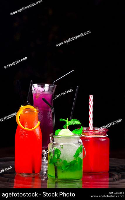 Different colored cocktails at a bar counter