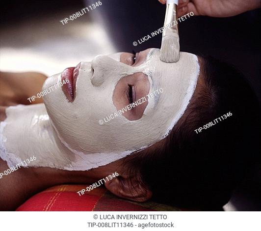 Woman getting facial mask