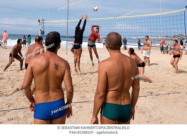 Residents play beach volleyball at Copacabana beach in Rio de Janiero, Brazil, July 30, 2016. The Rio 2016 Olympic Games take place from 05 to 21 August
