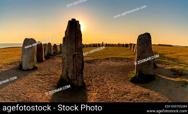 Landscape view of the prehistoric Ales Stenar ship setting on the southern coast of Sweden at sunset