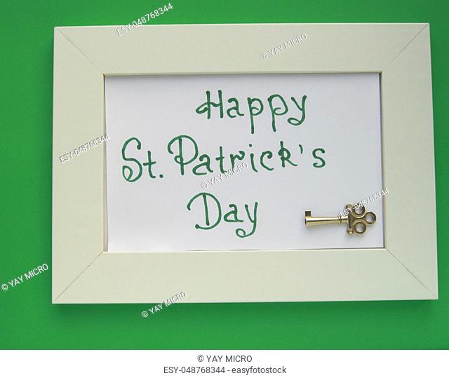 St. Patrick's day greeting card with white frame on green background, key to wealth and treasures