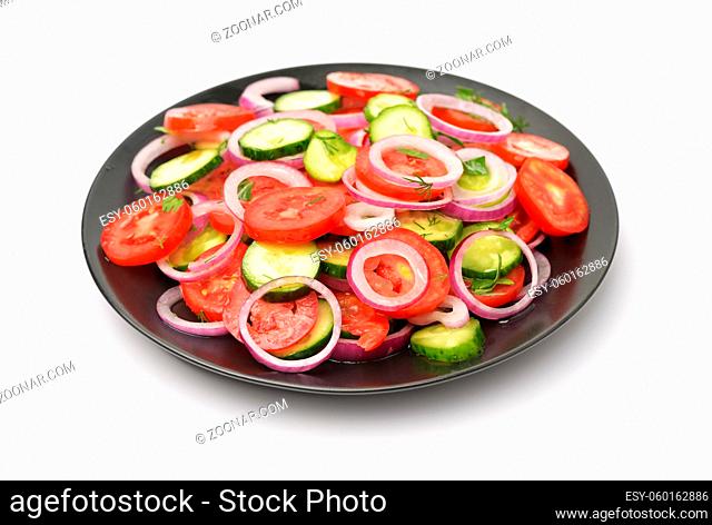 Raw tomatoes cucumber vegetable salad isolated on white
