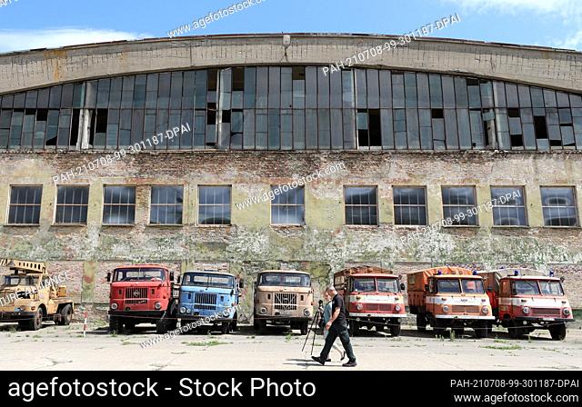 06 July 2021, Mecklenburg-Western Pomerania, Ribnitz-Damgarten: Former GDR trucks of the type ""Robur"" and ""W50"" stand in front of an exhibition hall in the...