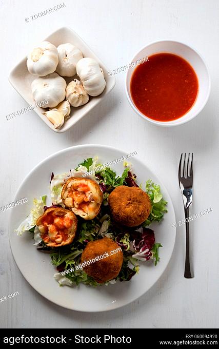 macaroni and cheese balls on white plate with salad