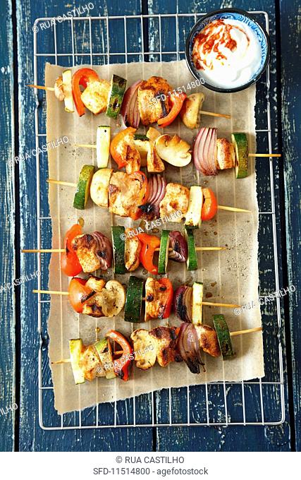 Chicken and vegetable skewers with a spicy yoghurt dip