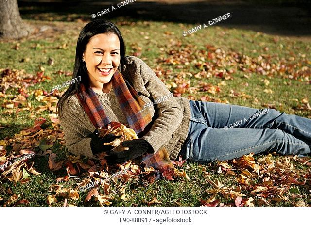Young woman w autumn leaves MR