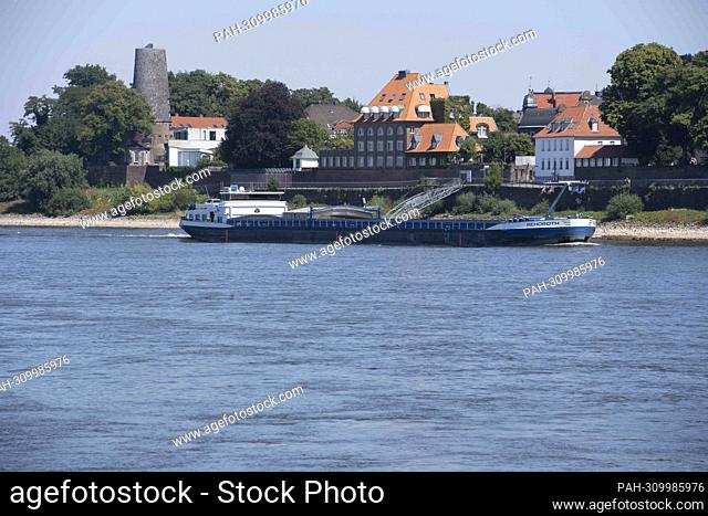 A cargo ship drives uphill in Hohe Kaiserswerth, the low water level only allows cargo ships to drive with less cargo, the Rhine has a low water level