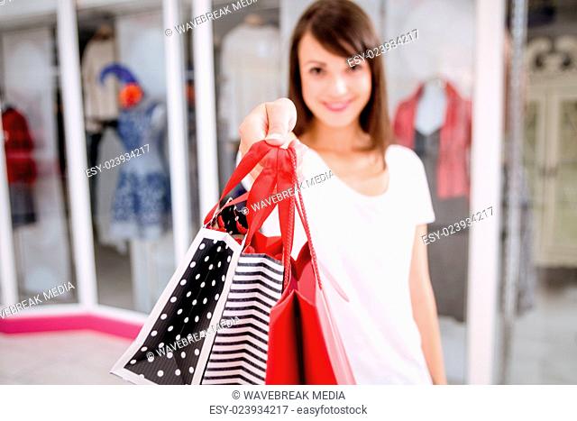 Portrait of woman showing her shopping bags