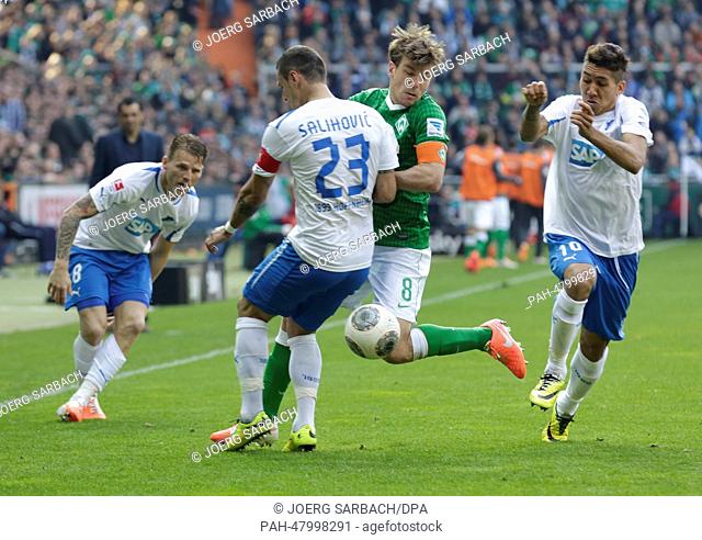 Hoffenheim's Eugen Polanski (L-R), Sejad Salihovic and Roberto Firmino stop Bremen's Clemens Fritz during the Bundesliga soccer match between Werder Bremen and...
