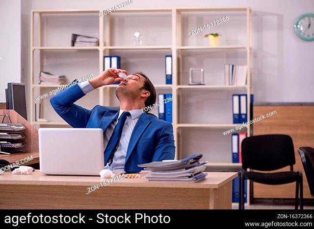 Sick businessman employee suffering at workplace