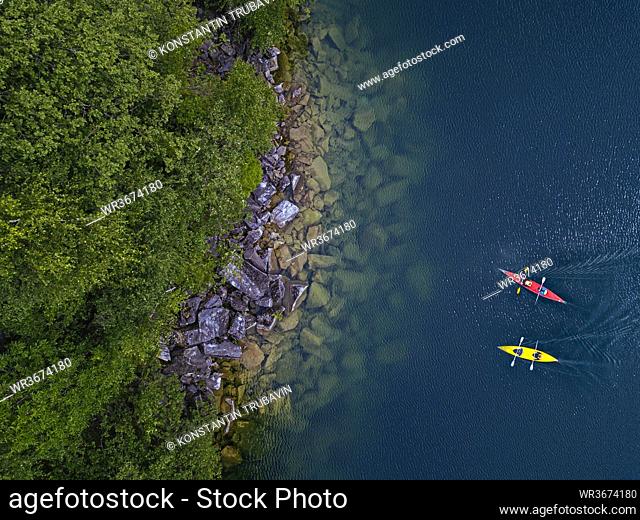 Russia, Republic of Karelia, Sortavala, Aerial view of kayakers at rocky shore of Lake Light