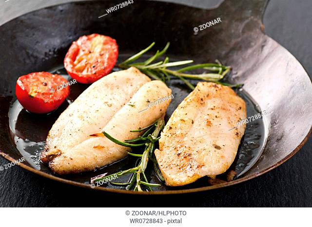 Fish steak fried in iron pan
