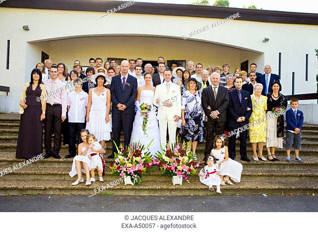 Wedding party group photo in front of the church