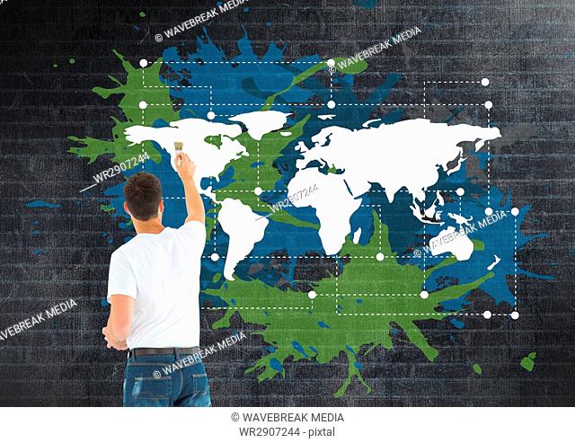 Man painting a Colorful Map with paint splatters on wall background