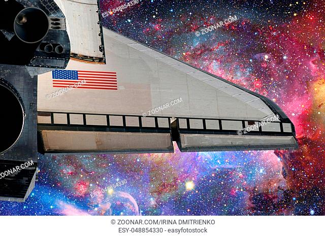 Space Shuttle over galaxy and space nebula. Elements of this image furnished by NASA